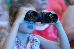 Little girl looking through binoculars