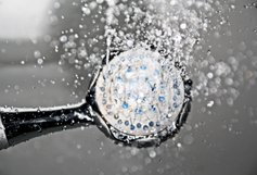 A shower head with water coming out of it.