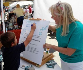 Scientologists encourages a child to pledge to live drug-free.