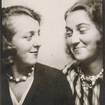 Two women smiling at each other