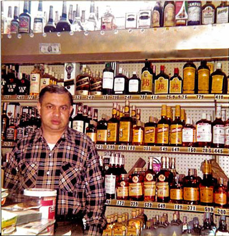 Isa’s father behind the register of their store