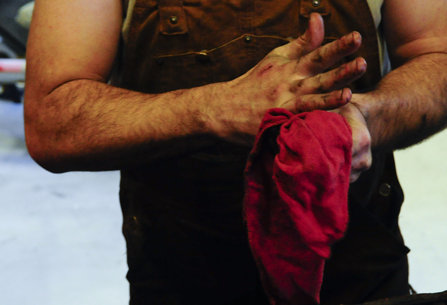 Mechanic wiping off hands
