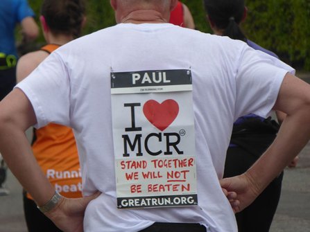 A man running a marathon with “Stand Together“ written on his t-shirt