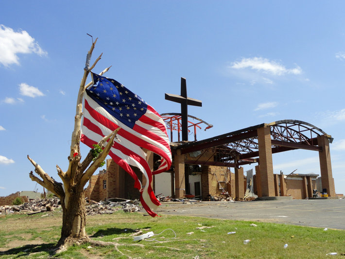 An American flag in front of a Church