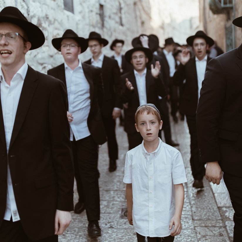Orthodox Jews walking down a street