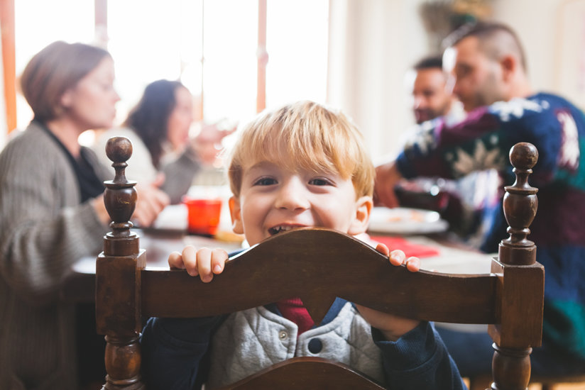 Child smiling at table