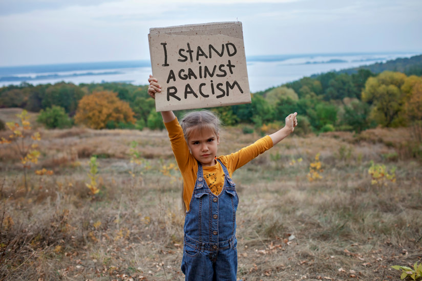 Girl holding anti-racism sign
