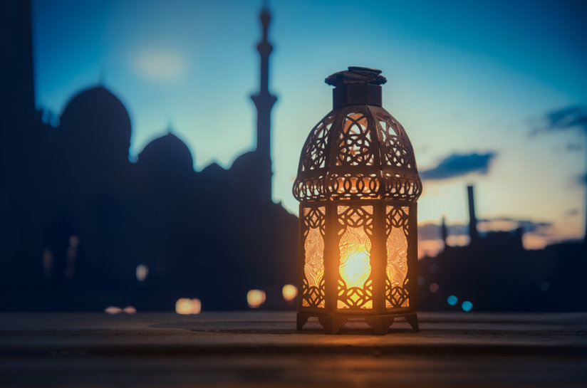 Glowing lantern with mosque in background