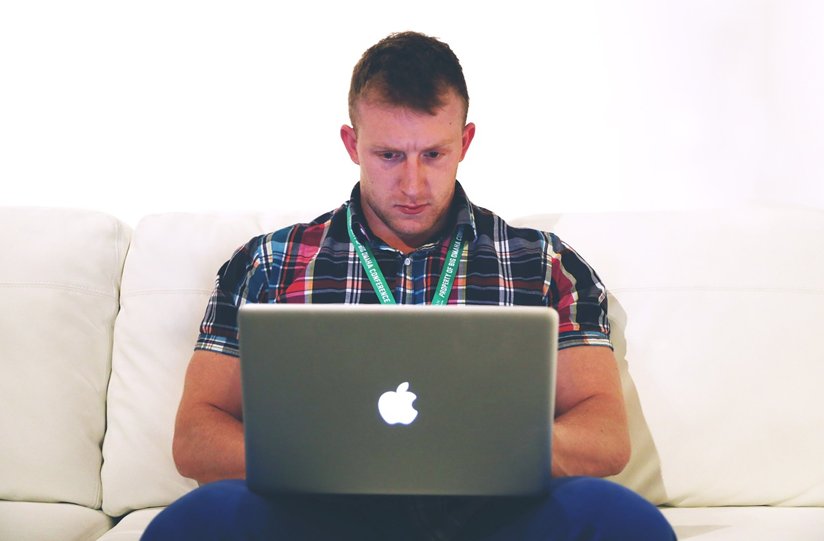 Man typing on a lap top