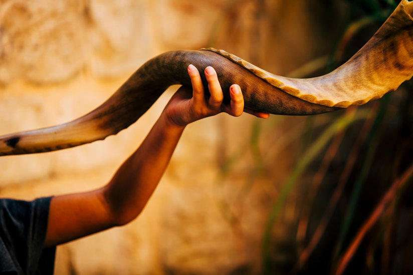 Young man calls in the new year with the shofar