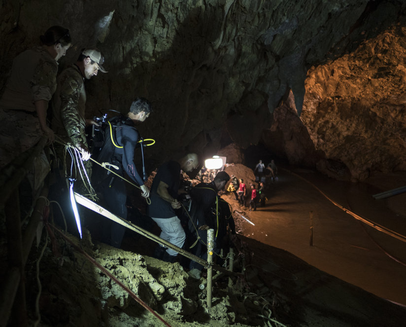 Rescuers descending into the cave