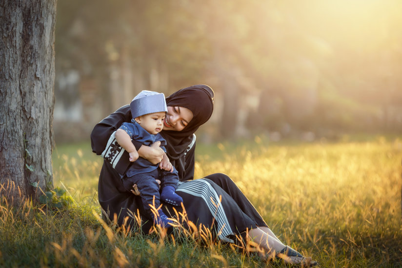 Muslim woman holding child
