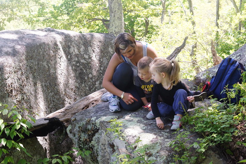 Woman with children on a rock