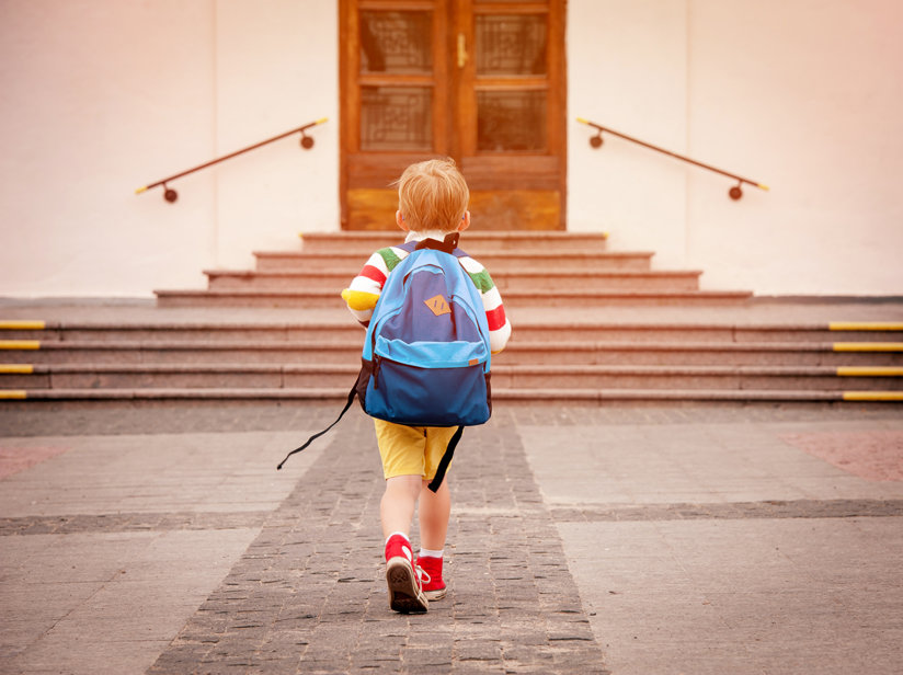 Boy approaching school doors