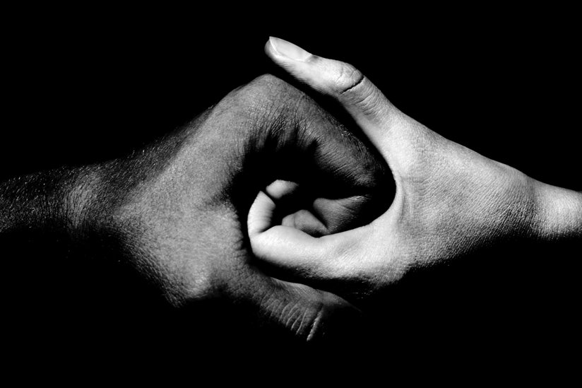 Two hands--one black, one white