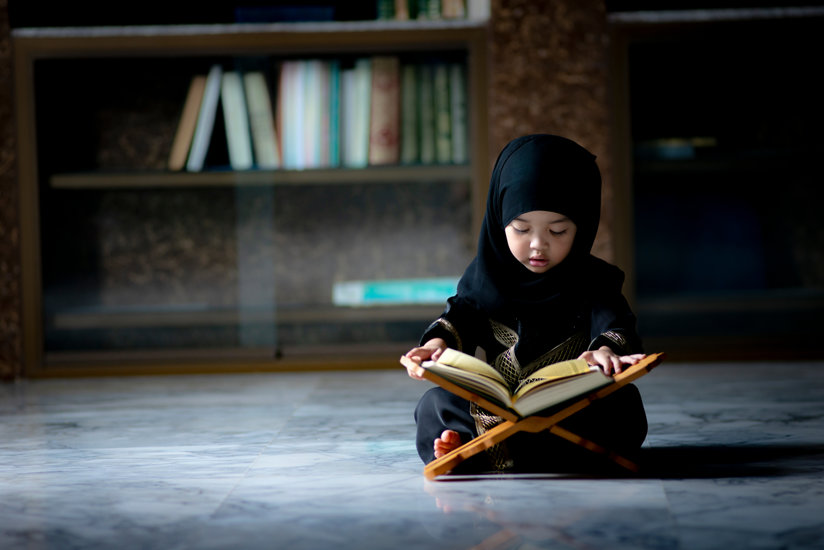 Muslim girl reading a book
